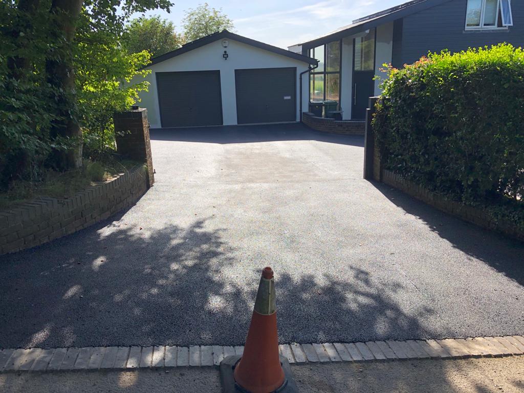 This is a photo of a bitumen driveway which is in the process of being installed by Forbes Road Tek